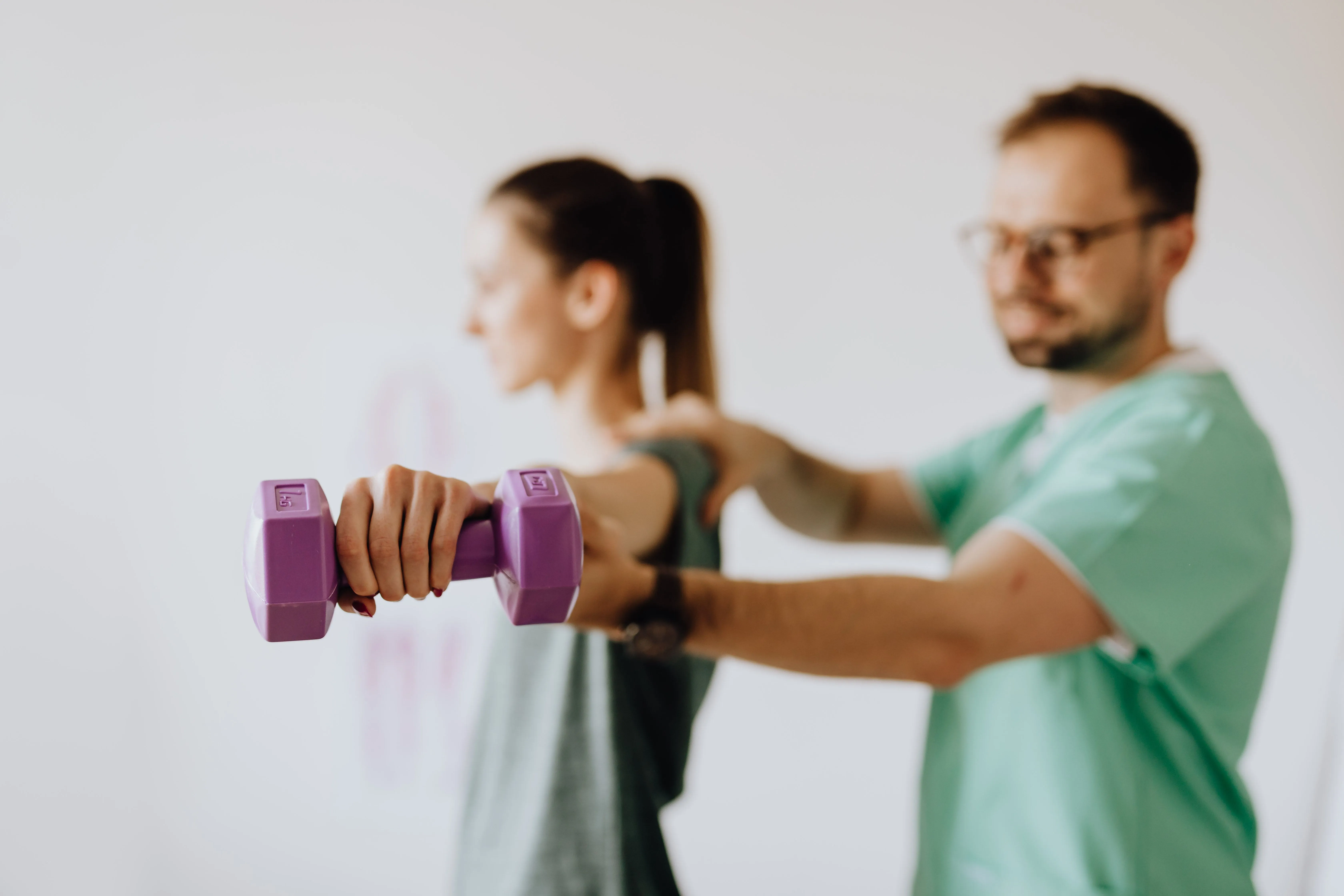 Physical therapist assisting a patient with orthopedic rehabilitation.