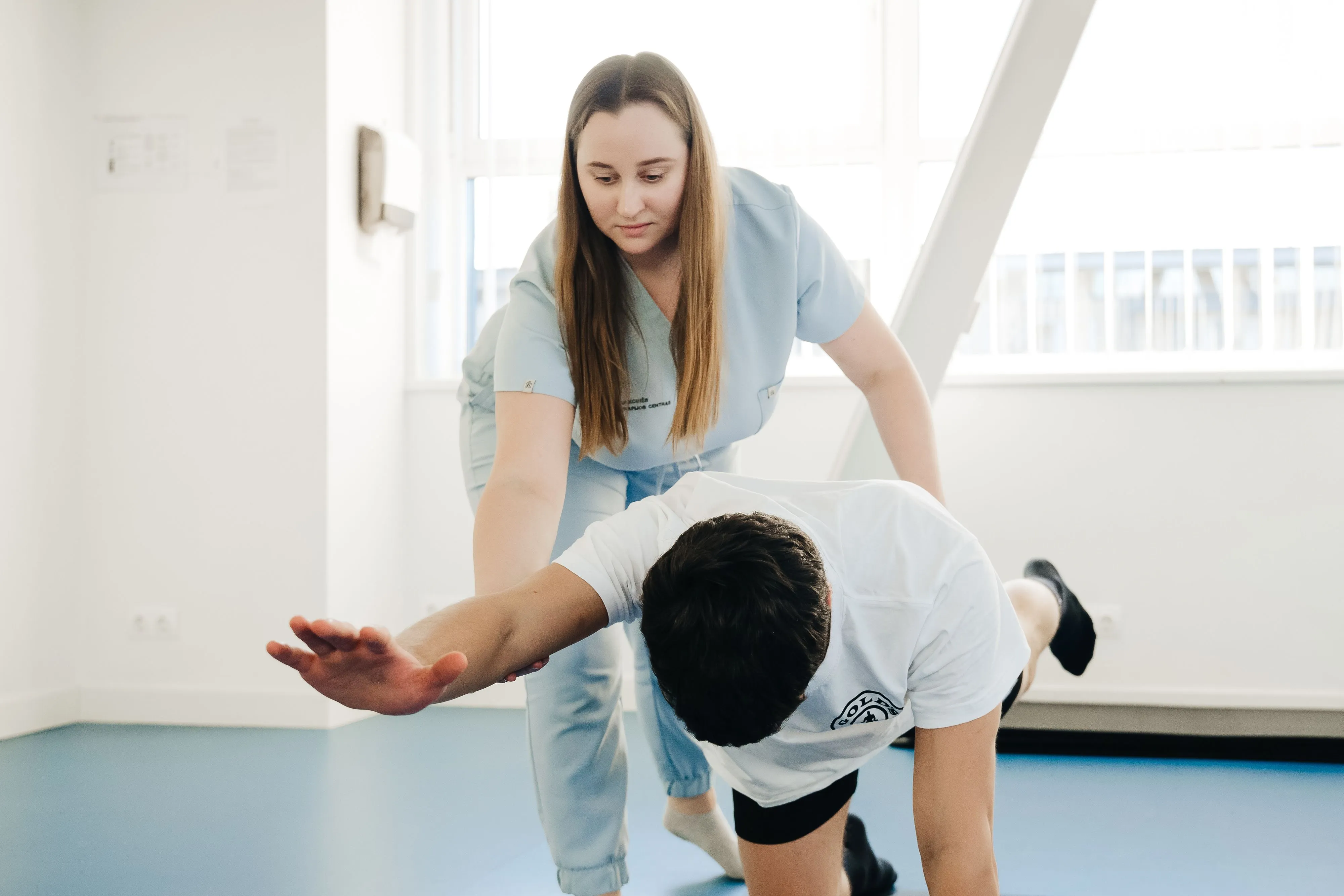 Physical therapist assisting a patient.